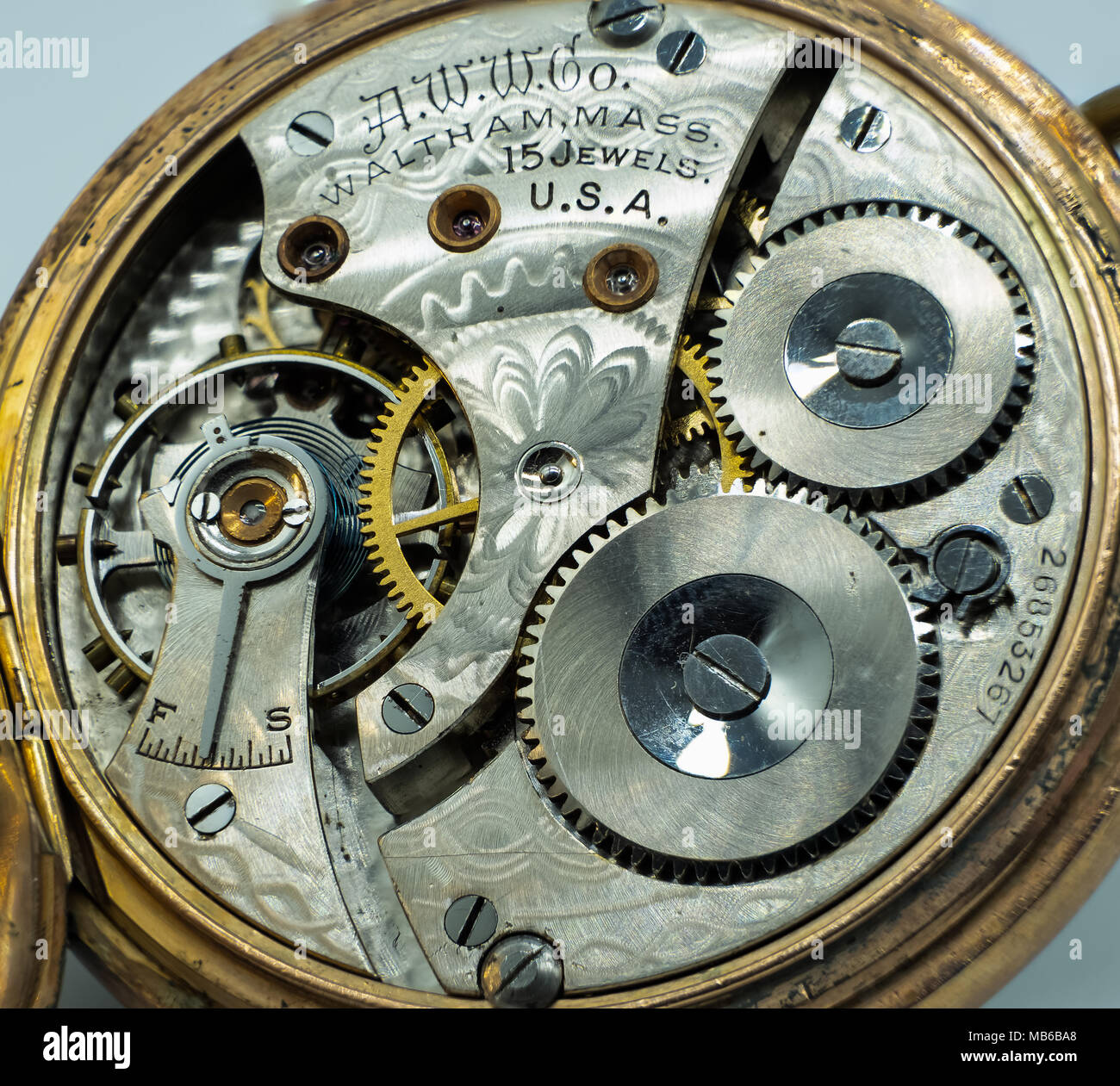 Antique Pocket Watch Open Displaying Windings and in need of restoration. A good image for a watch maker restorer. Stock Photo