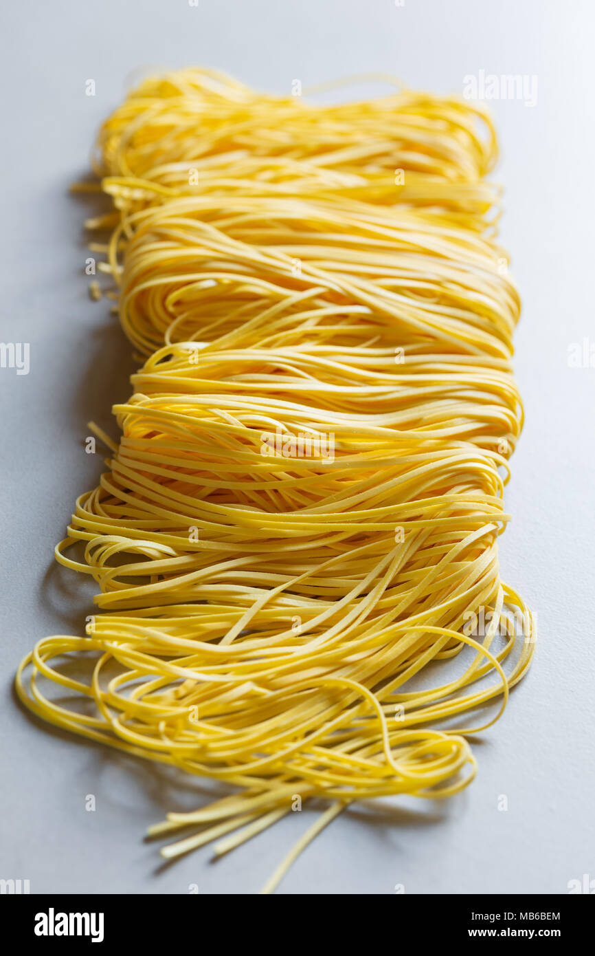 Raw tagliolini, type of italian pasta Stock Photo