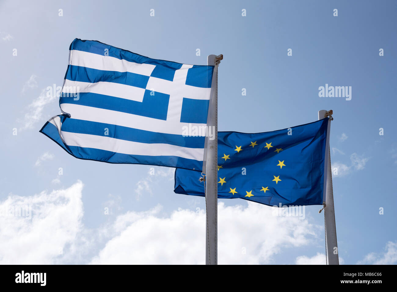 The Greek flag and the European Union flags flying together Stock Photo