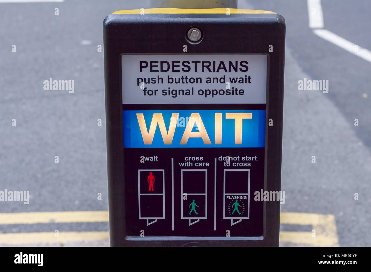 Illuminated 'Wait' pedestrian sign at a pedestrian crossing in central London, England Stock Photo