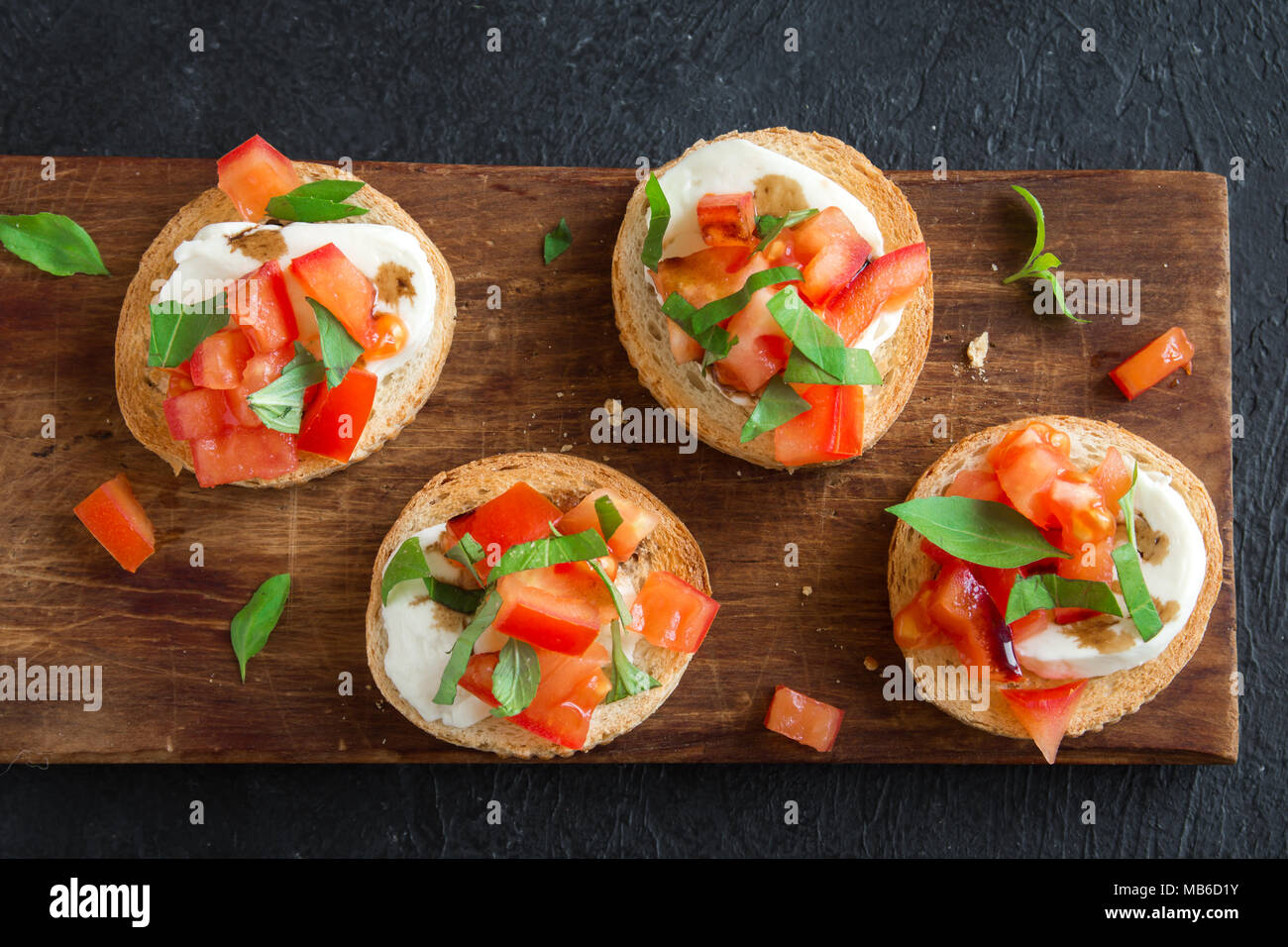 Italian bruschetta with chopped tomatoes, basil, mozzarella cheese and