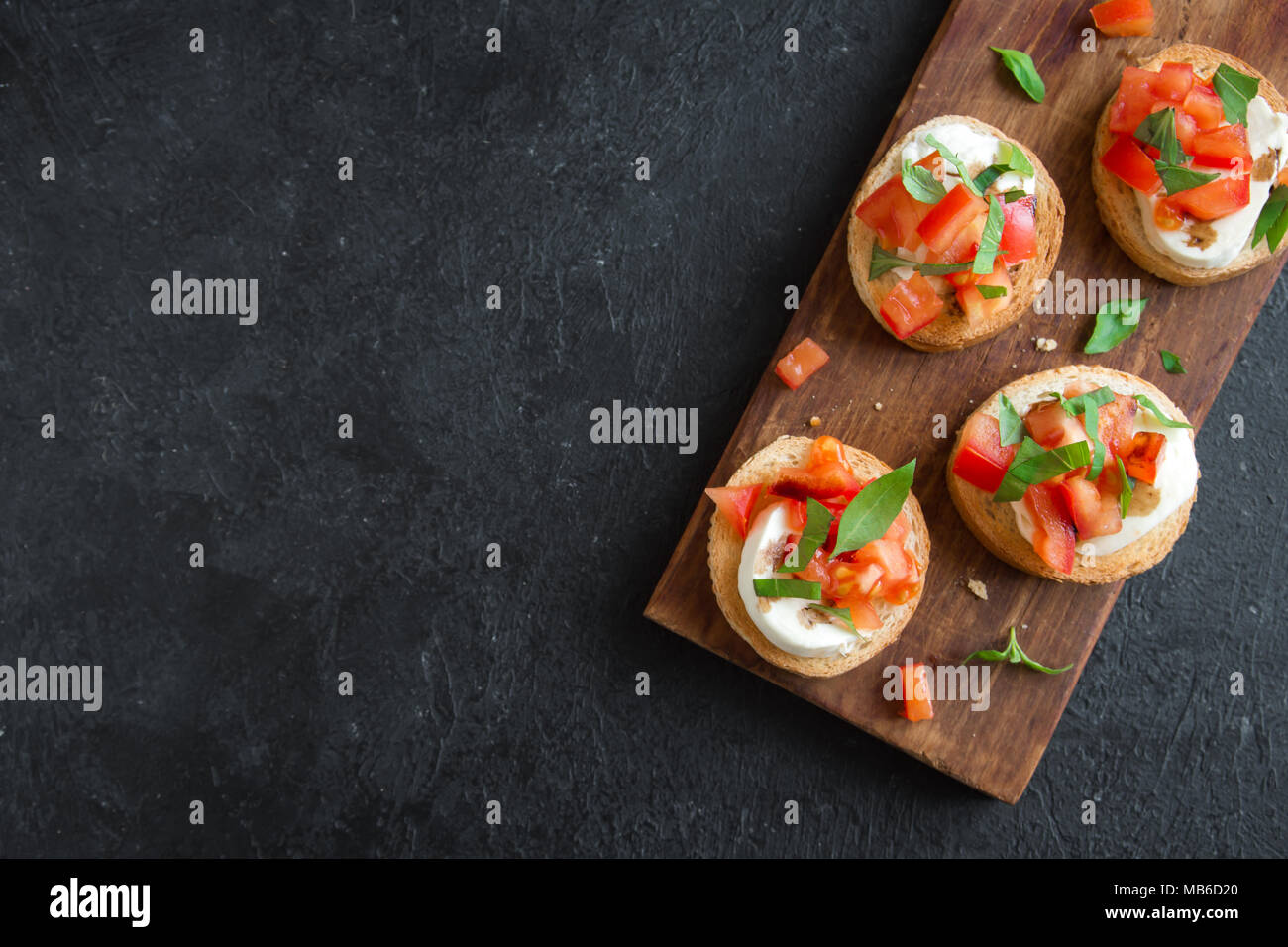 Italian bruschetta with chopped tomatoes, basil, mozzarella cheese and
