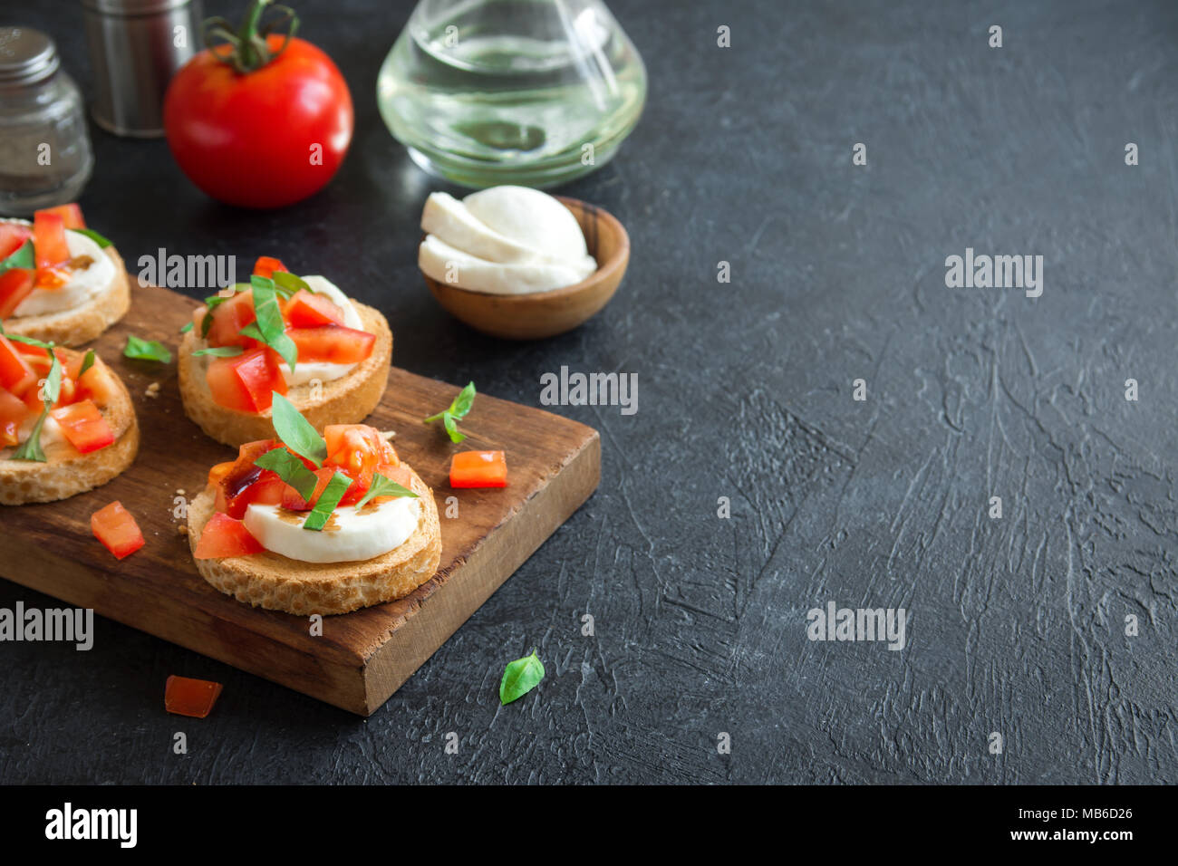 Italian bruschetta with chopped tomatoes, basil, mozzarella cheese and
