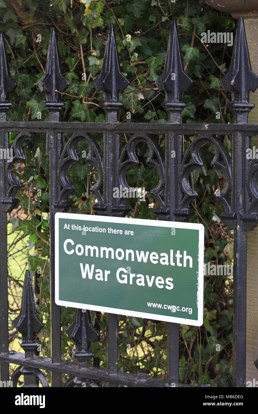 A commonwealth war grave sign attached to the gate at the front of the church in Gifford, Scotland Stock Photo
