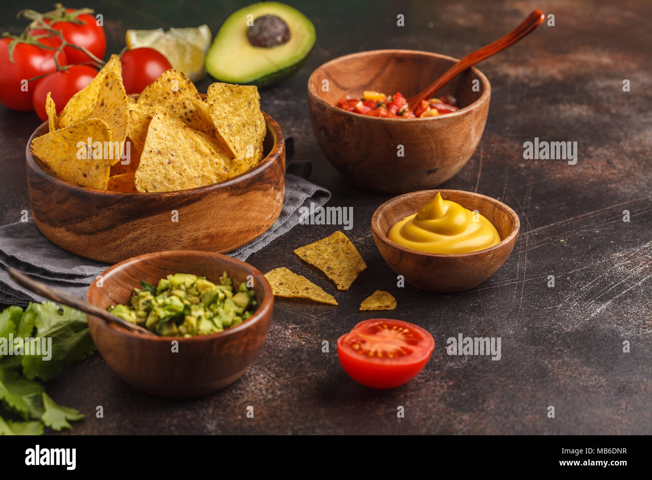 Nachos Totopos With Sauces Mexican Food Concept Yellow Corn Totopos Chips With Different Sauces Salsas Pico Del Gallo Guacamole Salsa Verde Chili Pebre Copy Space On Stone Gray Background Top View