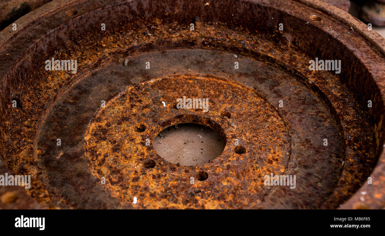 Heavily rusted vintage antique automotive clutch flywheel crankshaft bolt holes Stock Photo