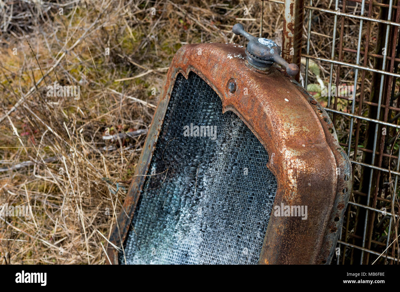 Vintage antique automotive rusted radiator and ornamental cap sitting ...