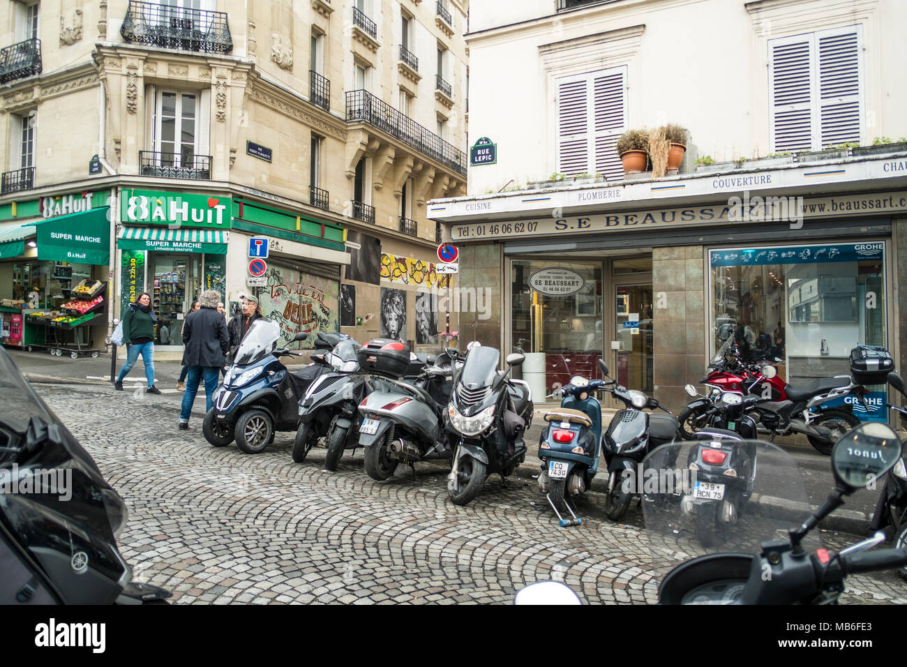 A typical Parisian street, Rue Robert Planquette, with quintesseitial scooters. Stock Photo