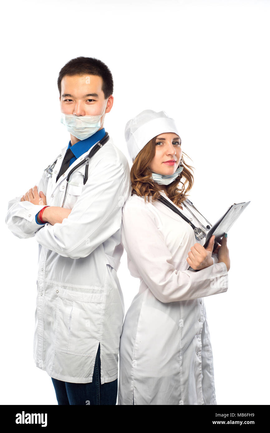 Happy team of two physicians standing back to back with arms folded isolated on white background Stock Photo