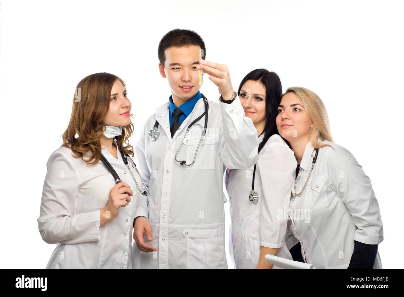 a group of young girls watching the result of the reaction of the drug in a test tube, under the guidance of a mentor Asian appearance Stock Photo