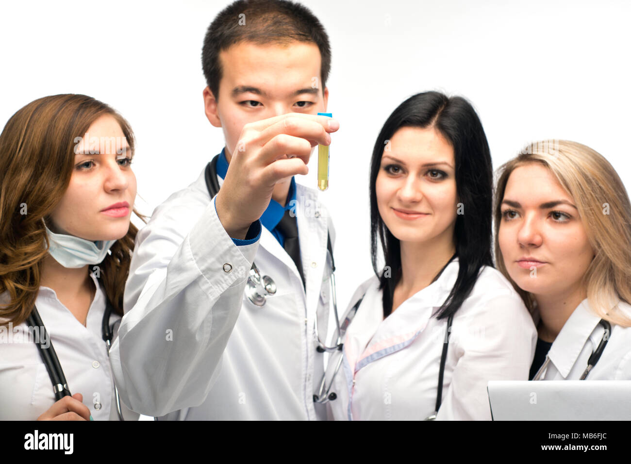 a group of young girls watching the result of the reaction of the drug in a test tube, under the guidance of a mentor Asian appearance Stock Photo
