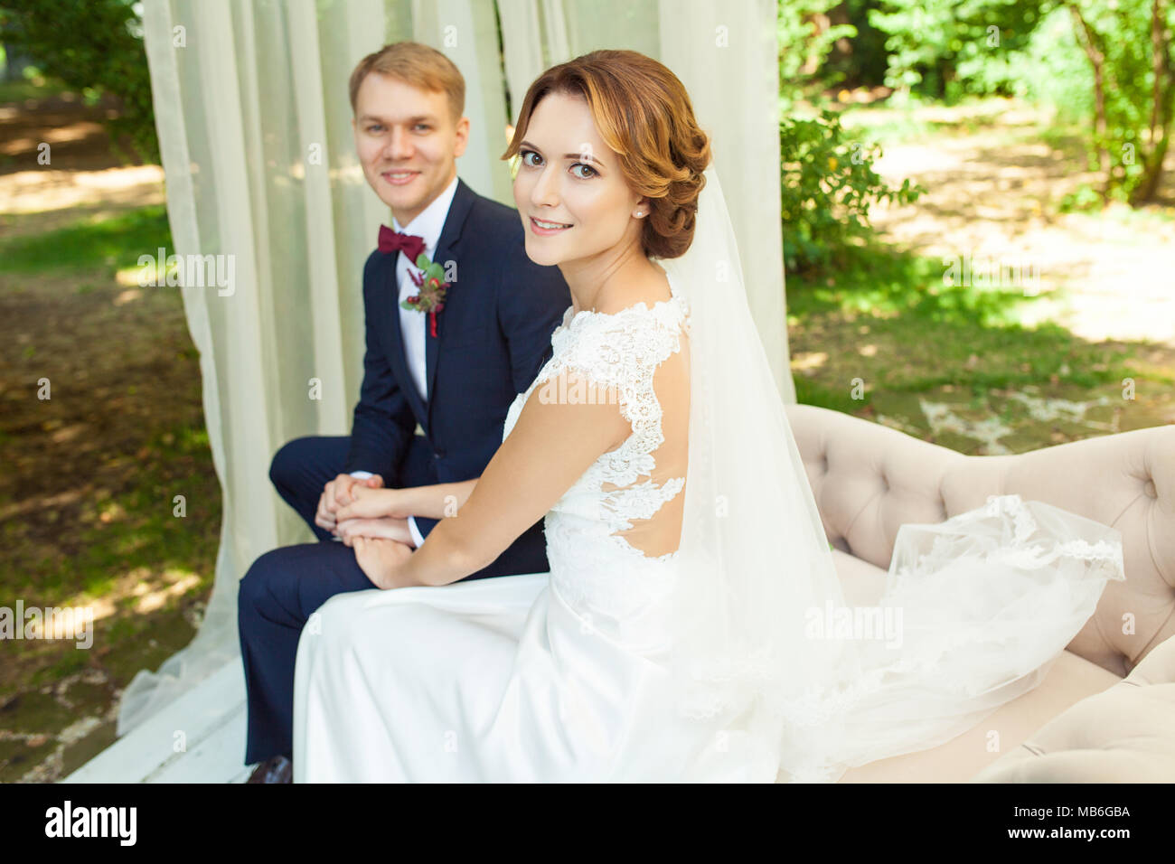 Happy newlyweds holding hands hi-res stock photography and images - Alamy