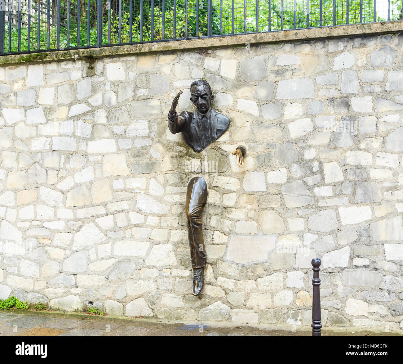 Jean Marais sculpture 'Le Passe-Muraille' (Man Who Walked through Walls, 1989) on Montmartre. Le Passe-Muraille is the title of a story by Marcel Ayme Stock Photo