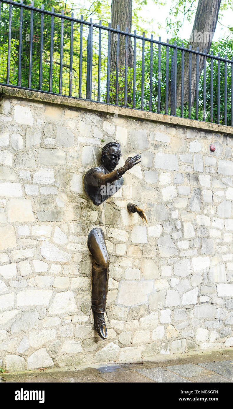 Jean Marais sculpture 'Le Passe-Muraille' (Man Who Walked through Walls, 1989) on Montmartre. Le Passe-Muraille is the title of a story by Marcel Ayme Stock Photo