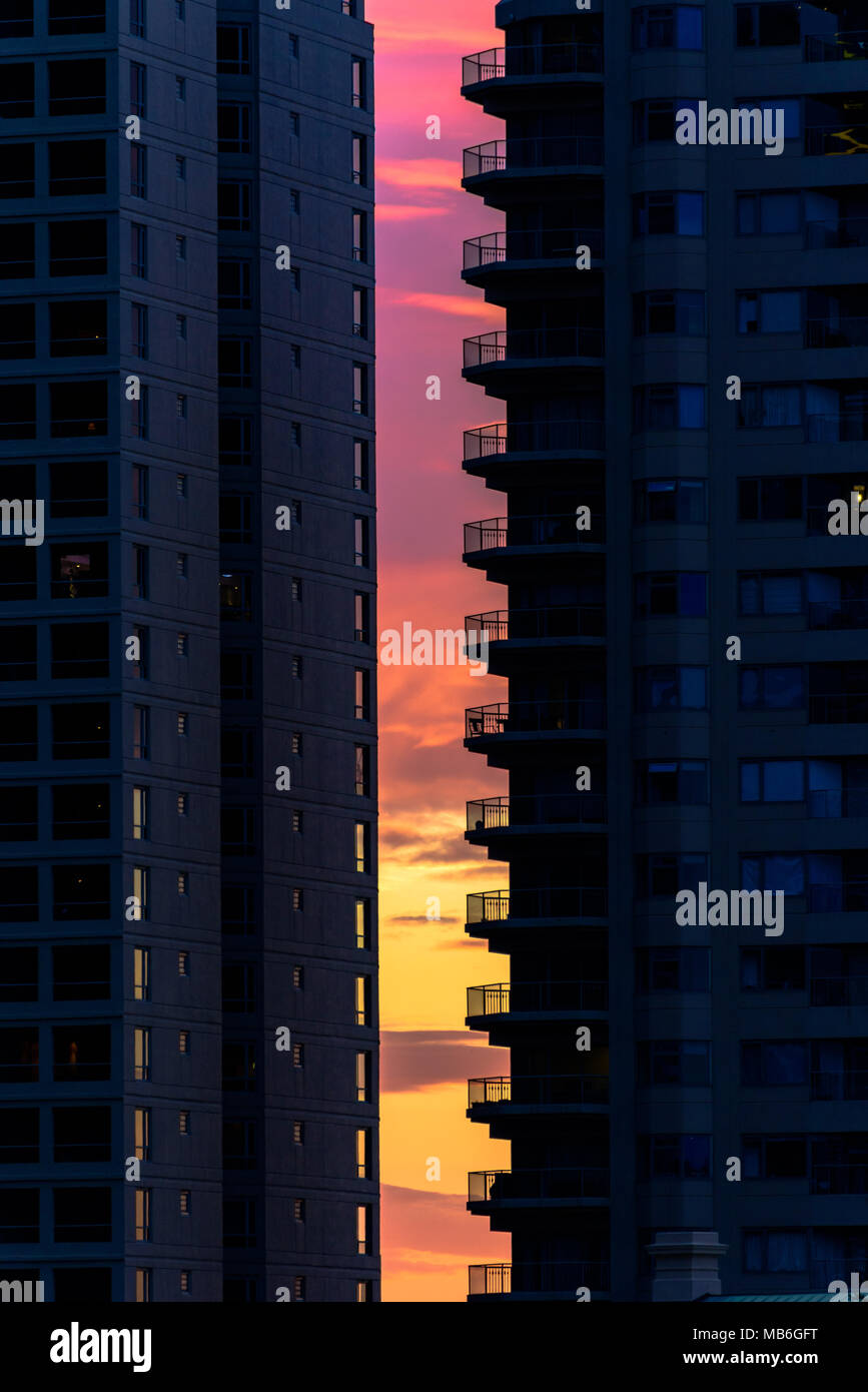 A vibrant sunset sky between two high-rise apartment buildings in Sydney, Australia Stock Photo