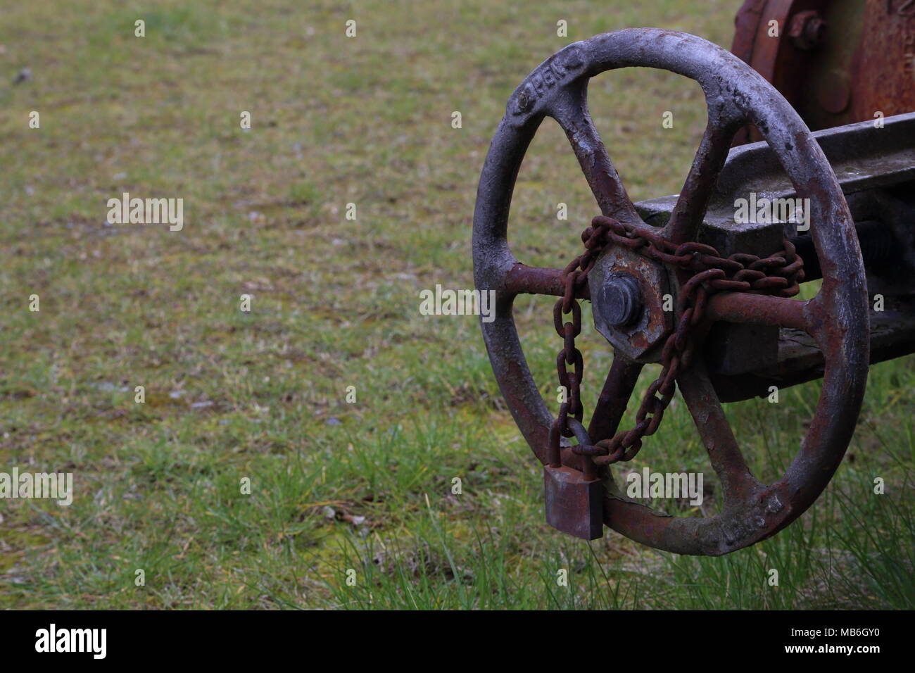 Rusty shut off valve at old factory site. Stock Photo