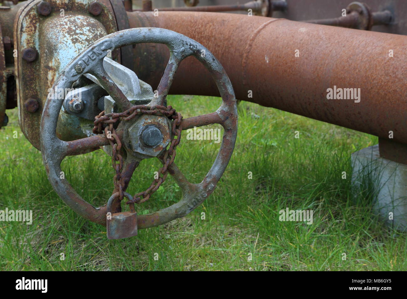 Rusty pipes and shut off valve at abandoned factory. Stock Photo