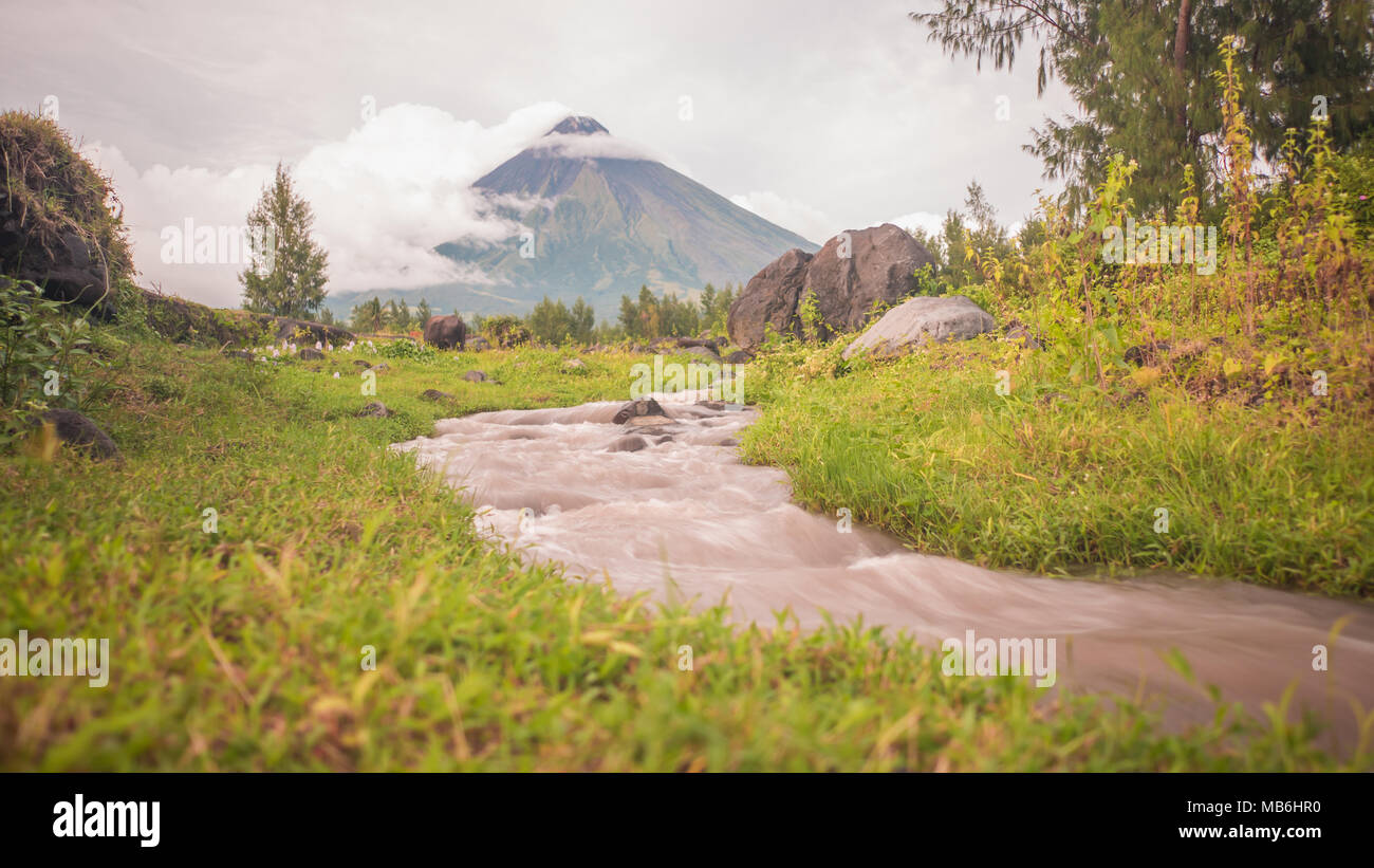 Foothills of the Mayon Volcano with flowing mountain rivers near Legazpi city in Philippines. Mayon Volcano is an active volcano and 2462 meters high. Stock Photo