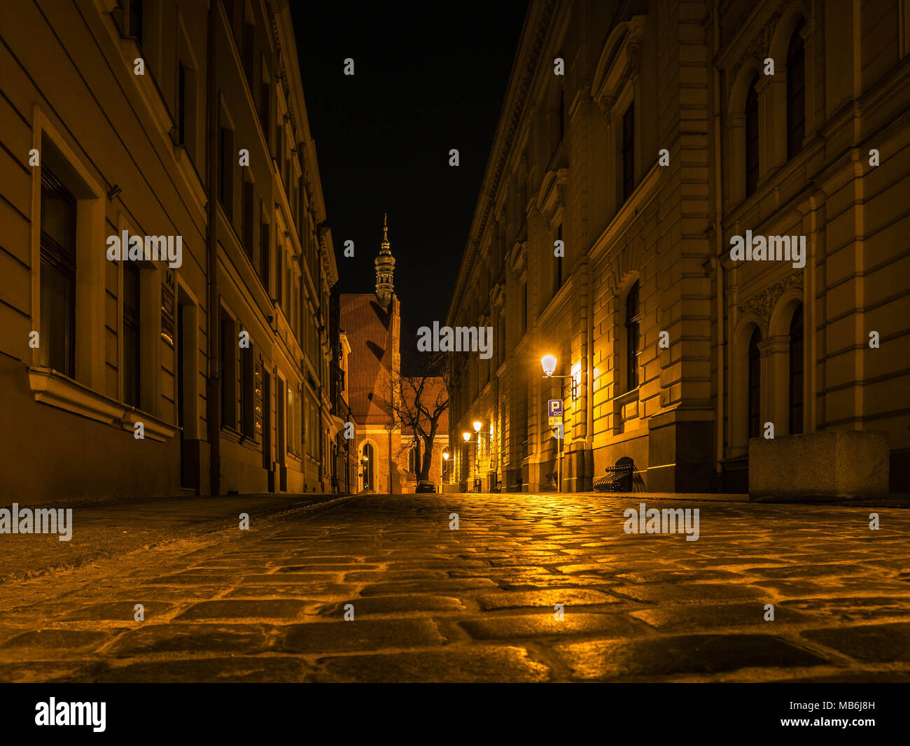Side street leading towards the Cathedral of Bydgoszcz at night Stock Photo