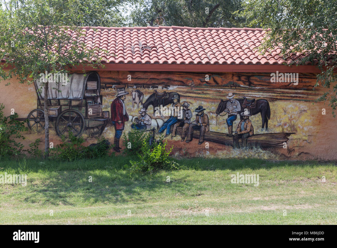 Wall painting of cowboys enjoying chow time in the old west in Turkey Texas Stock Photo