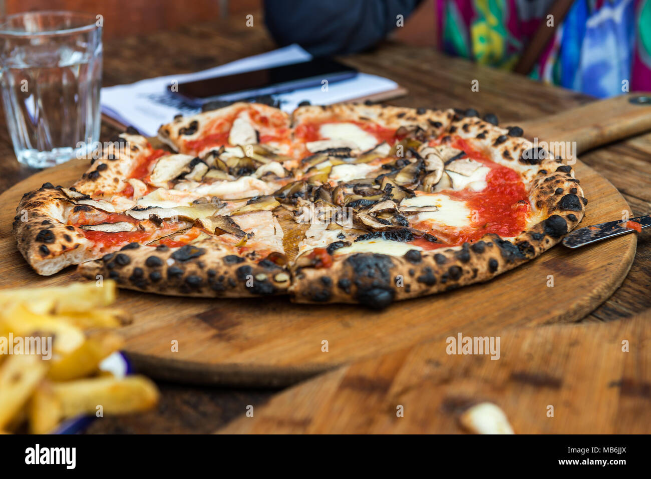 Portobello Italian pizza on the thin base with melted mozzarella cheese