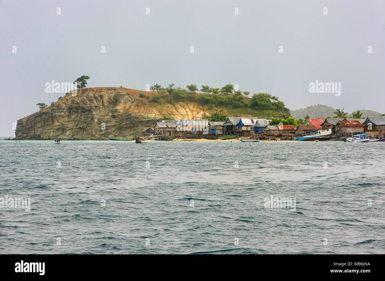 Small island with typical village in Komodo National Park, Nusa Tenggara, Indonesia. Komodo National Park is home to about 3500 people. Stock Photo