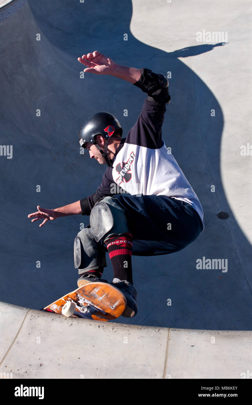 A veteran skateboarder rides the big bowl during 'Old Man Sundays,' at the skateboard park in Kennesaw, GA on November 24, 2013. Stock Photo
