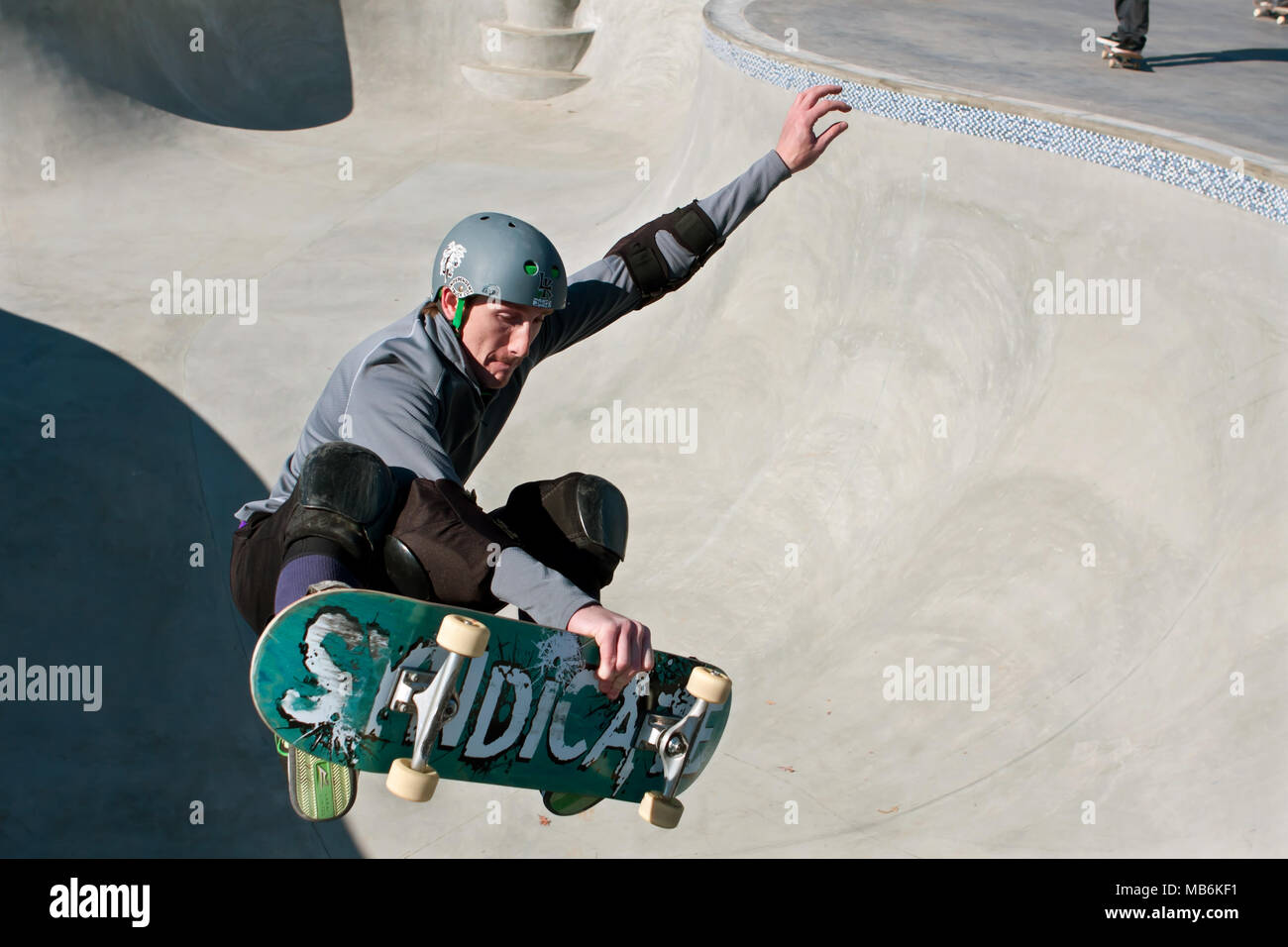 A veteran skateboarder catches air in the bowl during 'Old Man Sundays,' at the skateboard park in Kennesaw, GA on November 24, 2013. Stock Photo