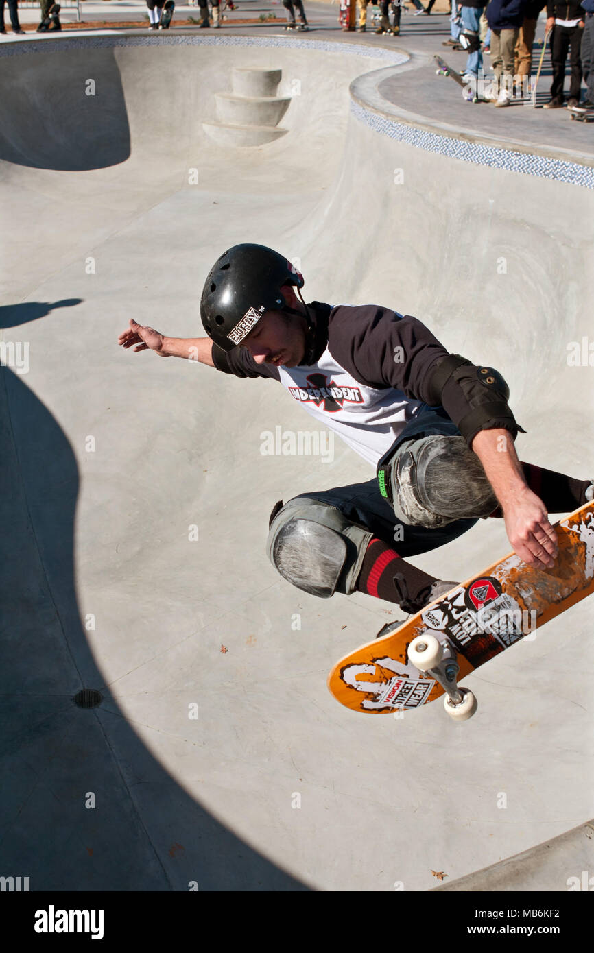 A veteran skateboarder gets airborne while grabbing his board during 'Old Man Sundays,' at the skateboard park in Kennesaw, GA on November 24, 2013. Stock Photo