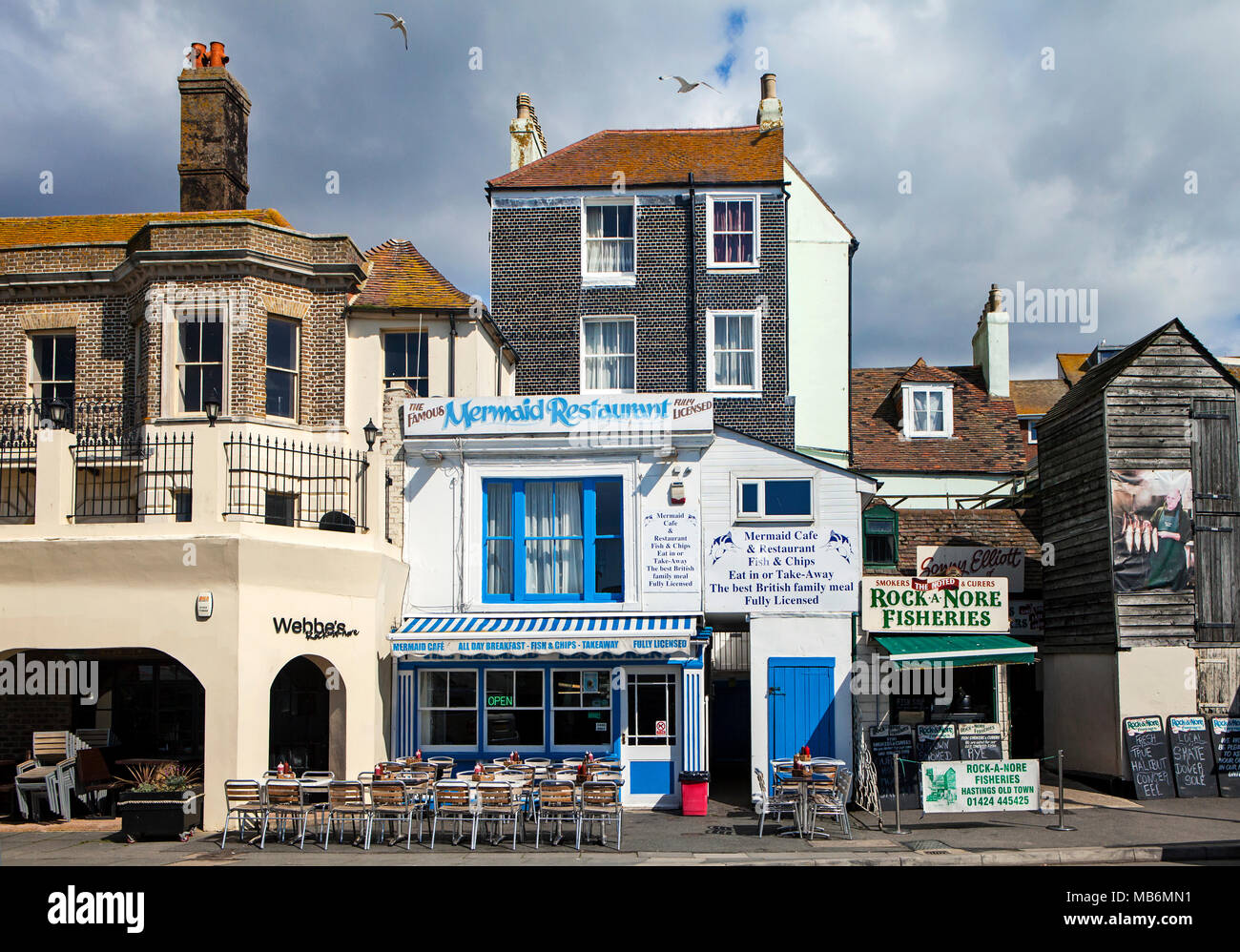 HASTINGS, UK - APRIL 5th, 2018: View of street in seaside town of Hastings with traditional fishery and restaurant. Hastings is a historic town known  Stock Photo