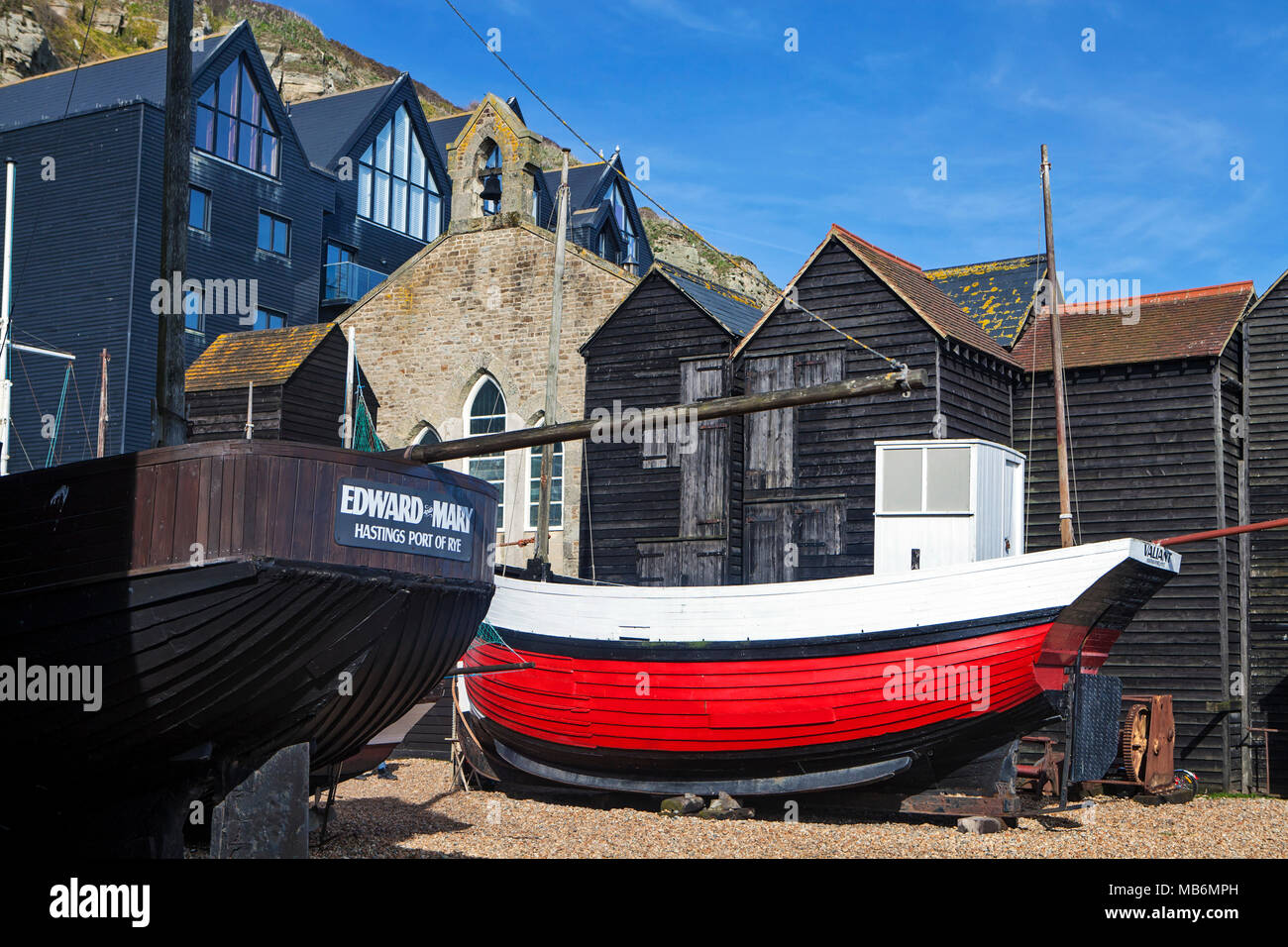 HASTINGS, UK - APRIL 5th, 2018: Boats and net shops in  Hastings, East Sussex. They are traditional storage buildings of the hastings fishing fleet. Stock Photo