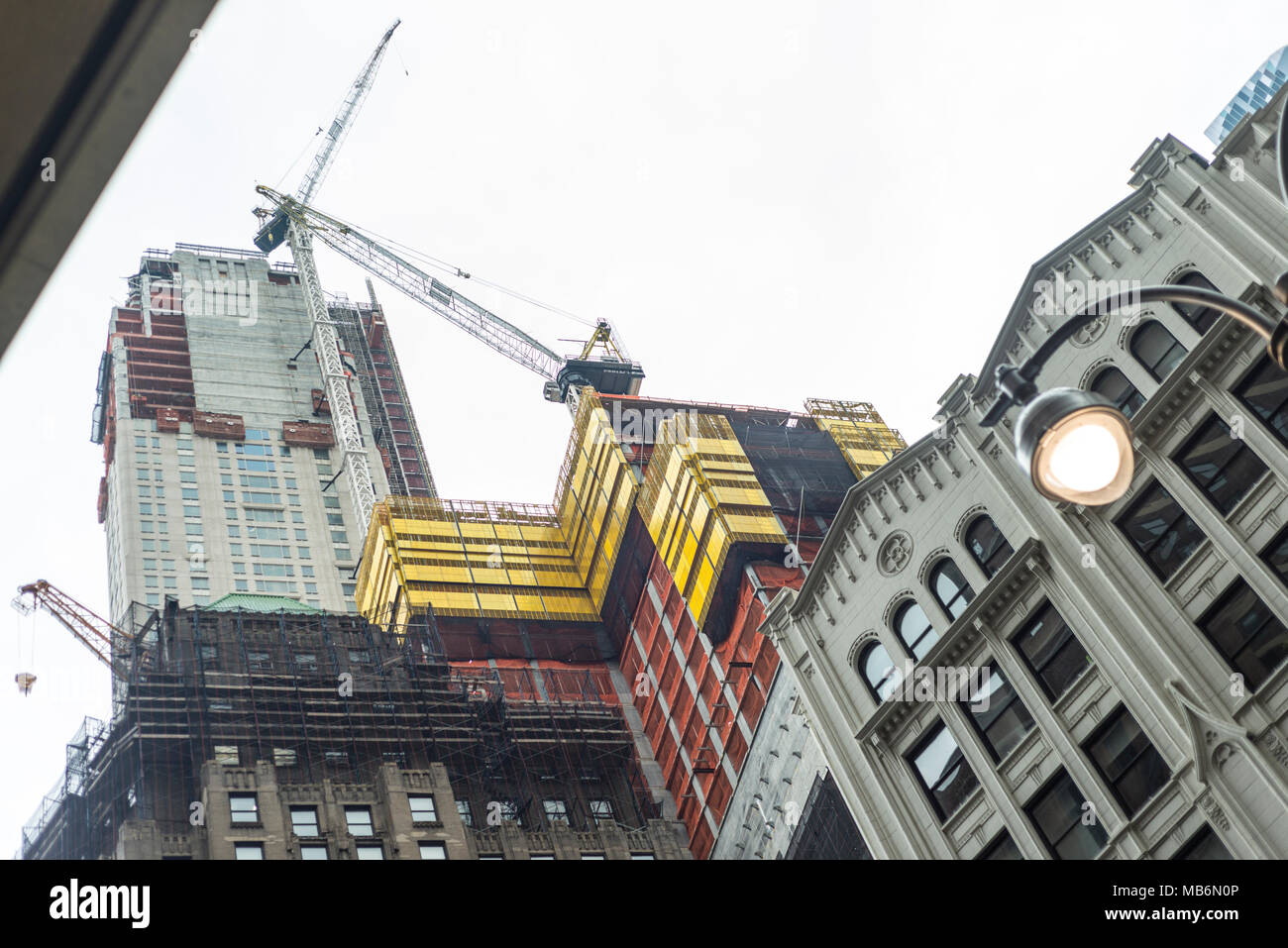 Full scale construction work on a skyscraper, somewhere near Columbus Circle in NYC, USA. Modern