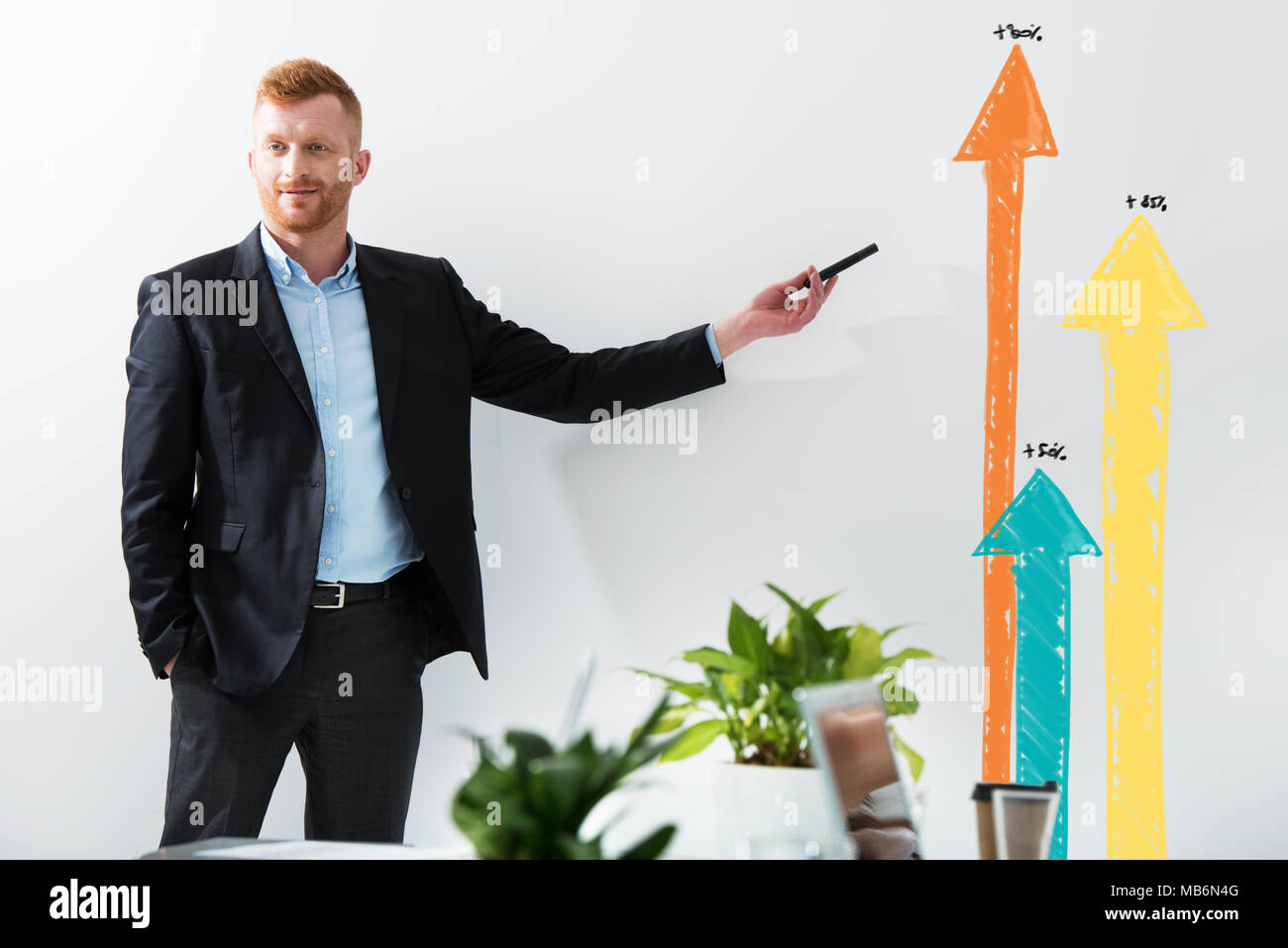 Businessman draws positive statistics of his company. Concept of success Stock Photo