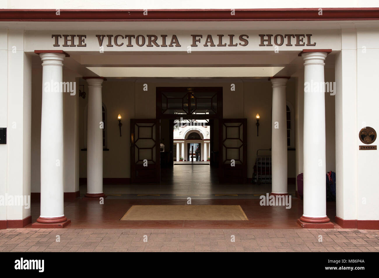 Entrance of the Victoria Falls Hotel at Victoria Falls, Zimbabwe. The luxury hotel opened in 1905. Stock Photo