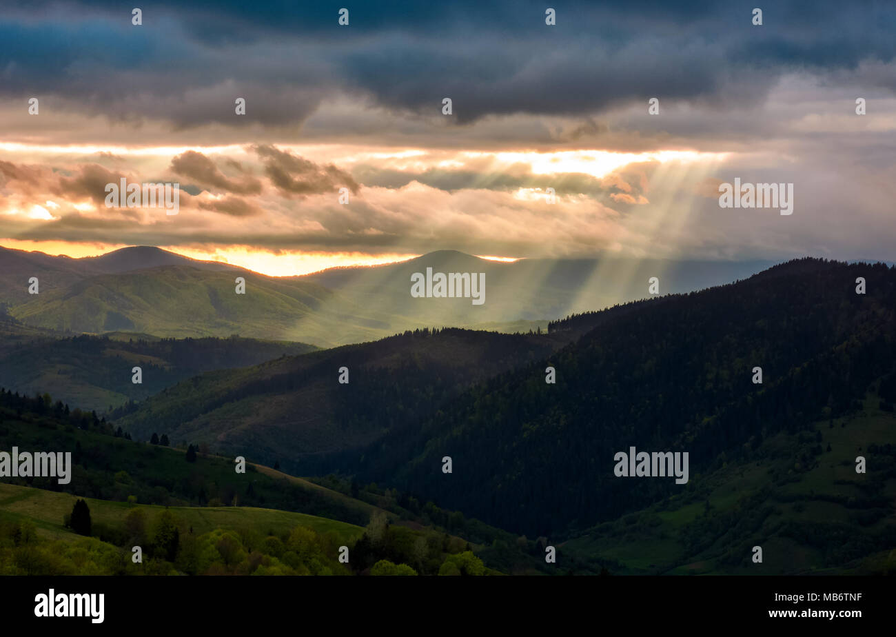 beams of light over the mountains. beautiful landscape in stormy weather Stock Photo