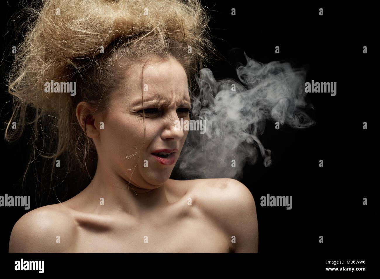 girl coughs from tobacco smoke on black background Stock Photo Alamy
