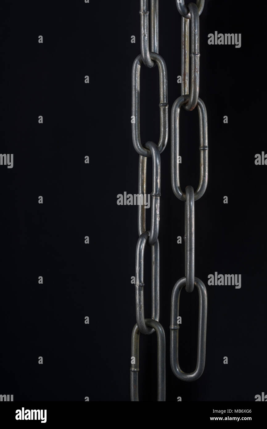 Metal chains against dark background -  as metaphor for cryptocurrency blockchain concept. China Blockchain conference metaphor. Stock Photo
