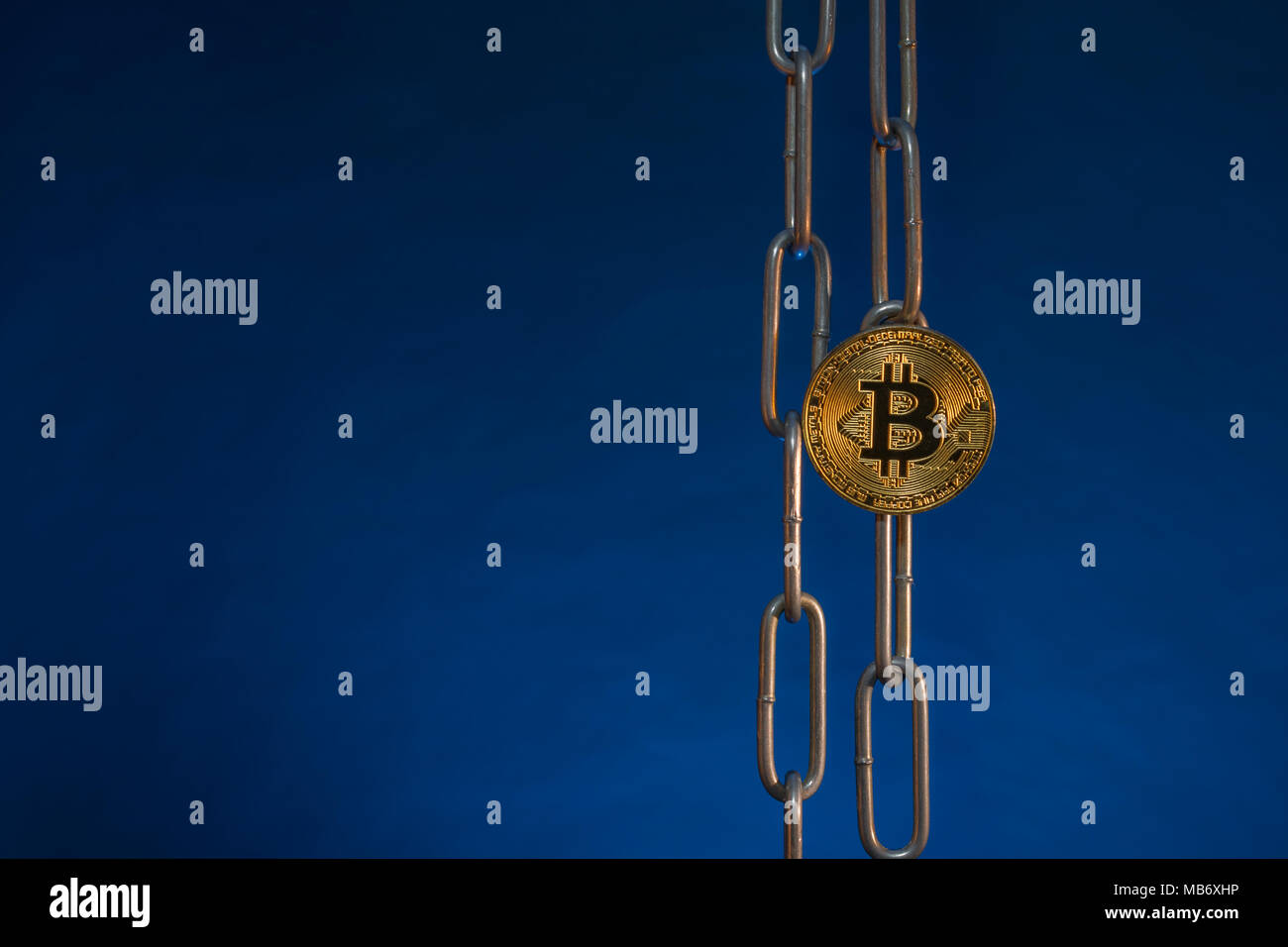 Metal chains with gold Bitcoin - as metaphor for cryptocurrency blockchain concept. China Blockchain conference metaphor, bitcoin crypto. Stock Photo