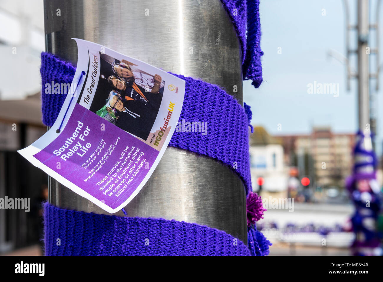 Knitted scarves yarnbombed around Southend on Sea High Street by Cancer Research UK to promote Southend Relay for Life. Will be donated to homeless Stock Photo