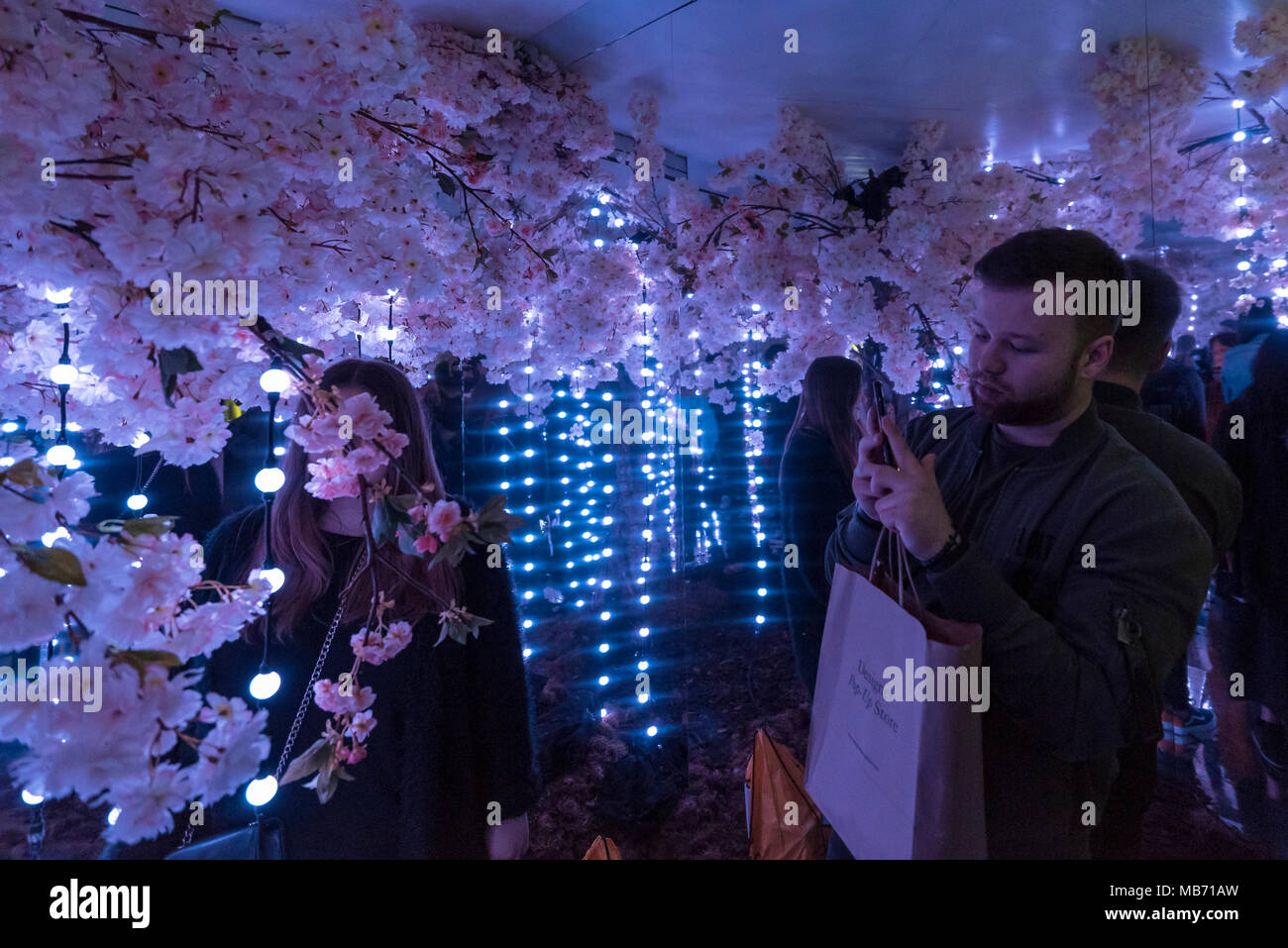 London, UK. 7 April 2018. Visitors walk through a room called The