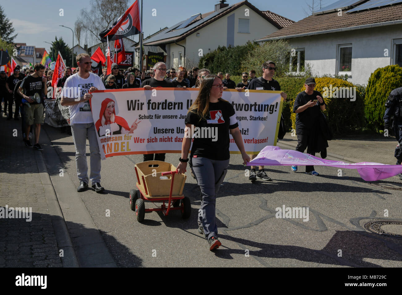Kandel, Germany. 7th April 2018. Protesters march with flags and banners through Kandel. Around 300 anti-fascists from different political parties and organisations marched through the city of Kandel, to show their opposition to the march by the right-wing protesters that was taking part at the same time and which used the remembrance of the murder of a girl late last year by an Asylum seeker, as pretext for a right-wing and racist protest. Credit: Michael Debets/Alamy Live News Stock Photo