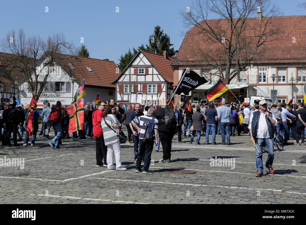 Kandel, Germany. 7th April 2018. Protesters have assembled at the market square for the opening rally. Around 500 people from right-wing organisations protested in the city of Kandel in Palatinate against refugees, foreigners and the German government. They called for more security of Germans and women from the alleged increased violence by refugees. The place of the protest was chosen because of the 2017 Kandel stabbing attack, in which a 15 year old girl was killed by an asylum seeker. Credit: Michael Debets/Alamy Live News Stock Photo