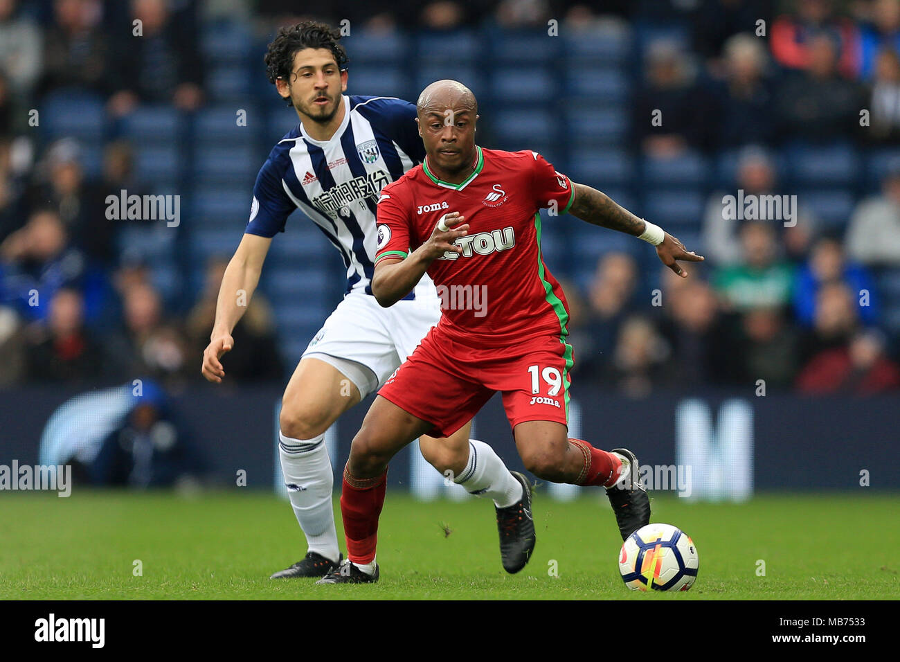 West Bromwich, UK. 7th April, 2018. Andre Ayew of Swansea City shields the ball from Ahmed Hegazy of West Bromwich Albion. Premier League match, West Bromwich Albion v Swansea City at the Hawthorns Stadium in West Bromwich on Saturday 7th April 2018.  This image may only be used for Editorial purposes. Editorial use only, license required for commercial use. No use in betting, games or a single club/league/player publications. Pic by Paul Roberts/Andrew Orchard sports photography/Alamy Live news Credit: Andrew Orchard sports photography/Alamy Live News Stock Photo