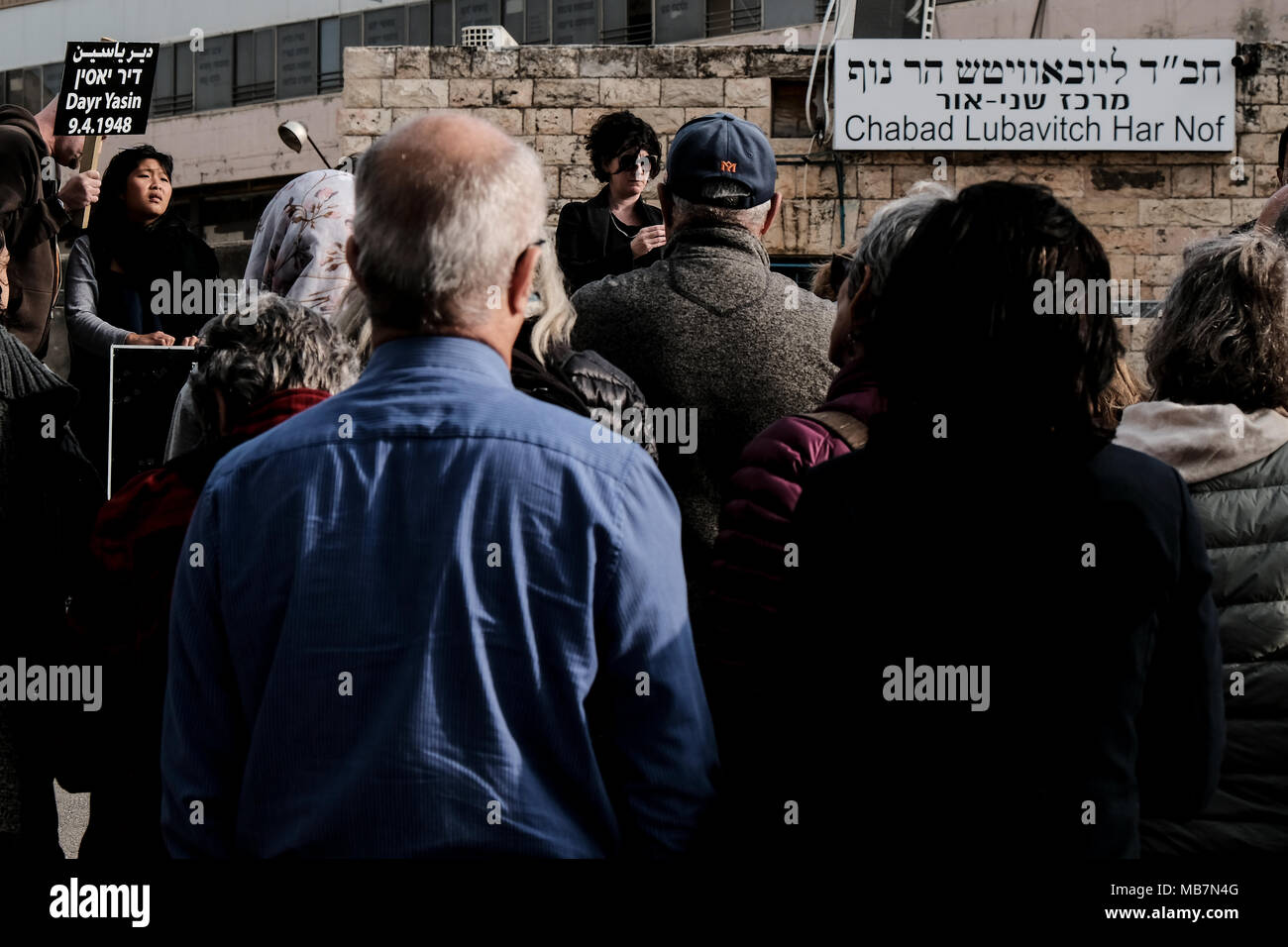 Jerusalem, Israel. 8th April, 2018. Jews and Arabs march together in a procession carrying plaques bearing the names of the victims of the Deir Yassin Massacre, under tight police protection, to the few remaining structures of the 1948 Arab village invaded and destroyed. Commemoration organized by Zochrot (Remembering), seeking to raise public awareness of the Palestinian Nakba (Catastrophe). Credit: Nir Alon/Alamy Live News Stock Photo