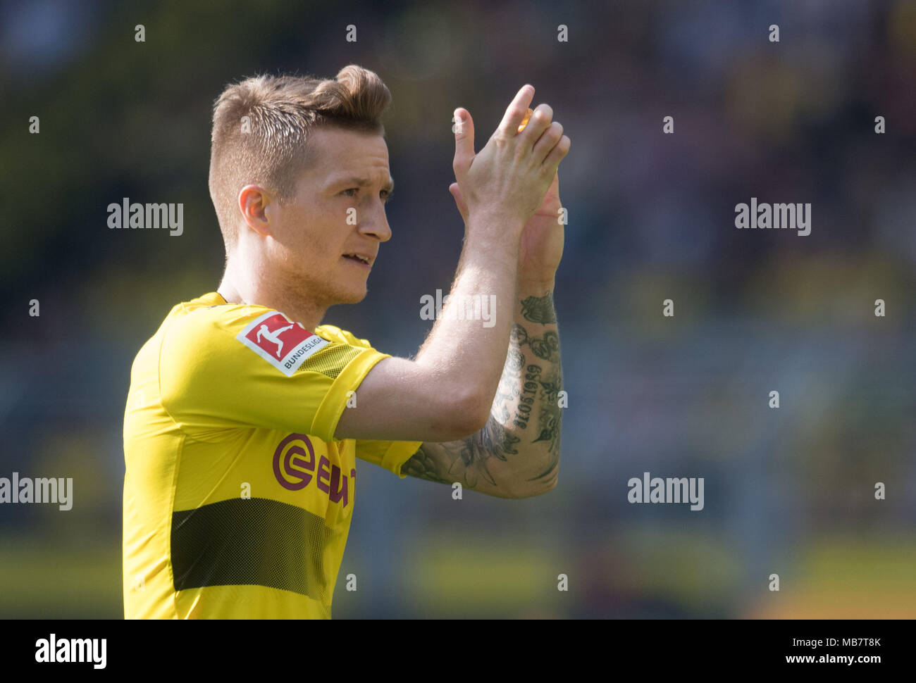 08 April 2018, Germany, Dortmund. Football German Bundesliga, Borussia Dortmund vs VfB Stuttgart at the Signal Iduna Park. Dortmund's Marco Reus clapping the fans after being substituted. Photo: Bernd Thissen/dpa - IMPORTANT NOTICE: Due to the German Football League·s (DFL) accreditation regulations, publication and redistribution online and in online media is limited during the match to fifteen images per match Stock Photo
