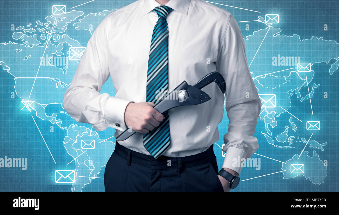 Businessman holding tool with global map graphic on the background Stock Photo