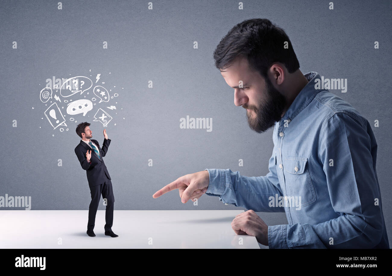 Young professional businessman being angry with an other miniature ...