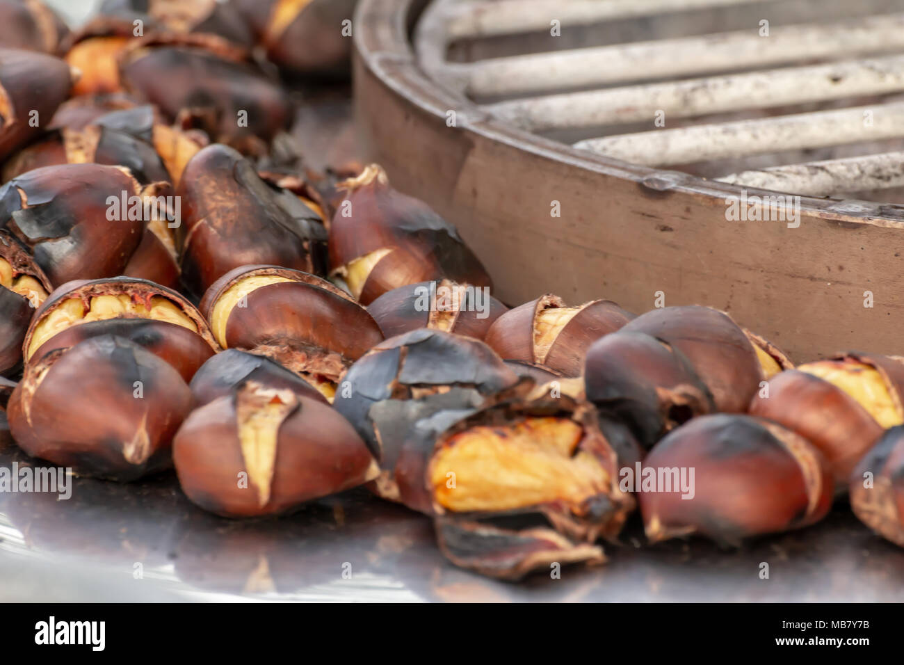 Roasted chestnuts for sale on the streets in autumn and winter season. Castanea sativa Stock Photo