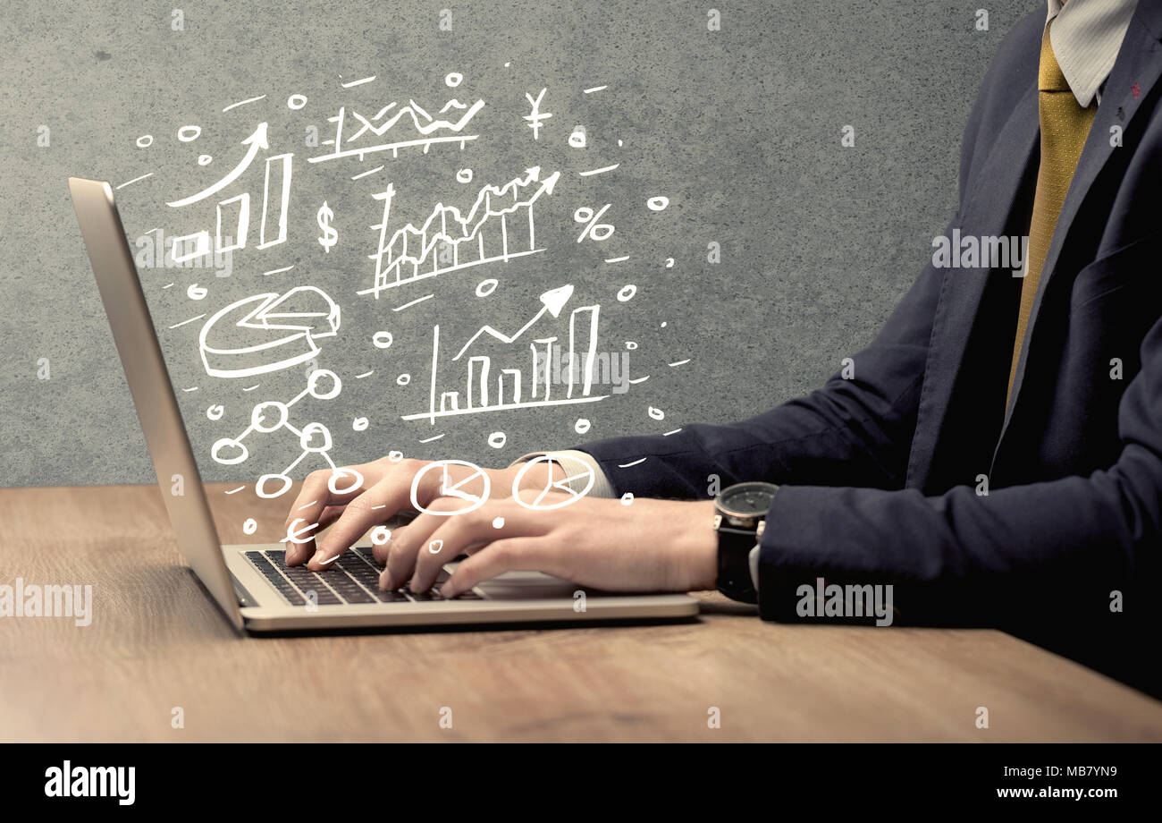 Sales person in suit using a laptop to calculate pie chart and