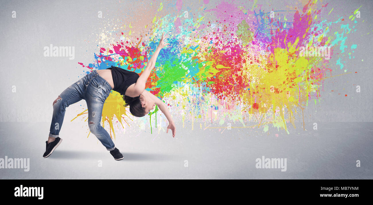 A funky contemporary hip hop dancer dancing in front of grey background  with colorful bright paint splatter concept Stock Photo - Alamy